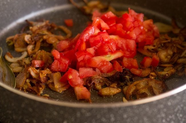 adding tomato for palak biryani