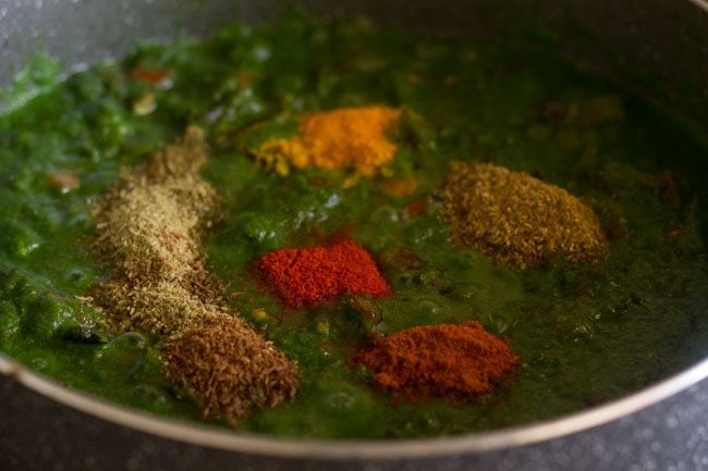 adding spices for palak biryani