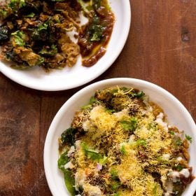 palak chaat served in white plates on a wooden table.