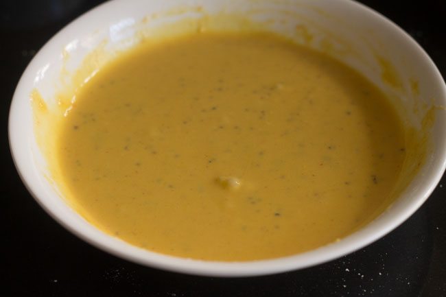 whisking the ingredients in the bowl till a smooth batter is formed. 