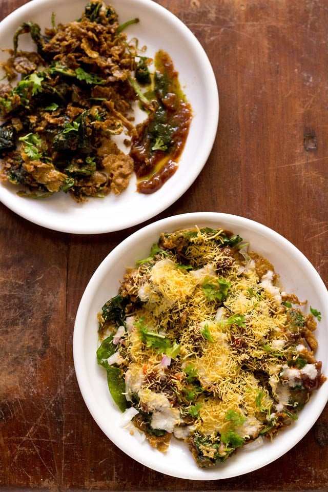 palak chaat served in white plates on a wooden table.