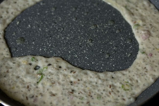 poured rava dosa batter from the sides