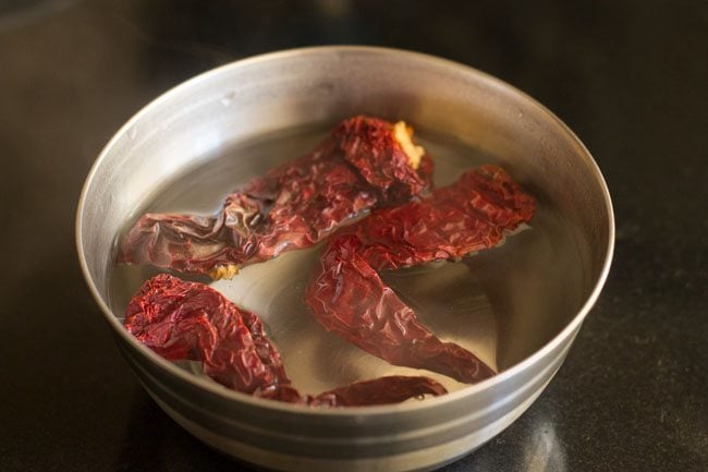 soaking dried red chilies in warm water 