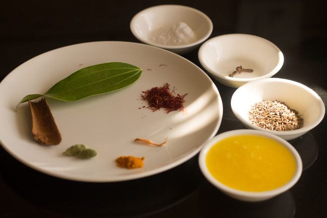 spices and ghee arranged in white dishes