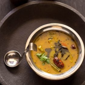 udupi sambar in a bowl with spoon