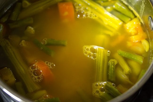 mixing dal and vegetables in pan for udupi sambar 