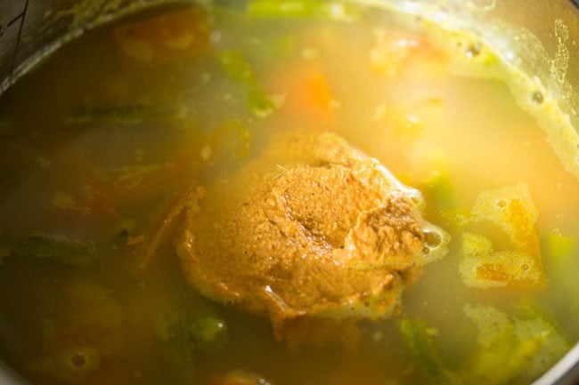 adding prepared sambar paste in pan for udupi sambar 