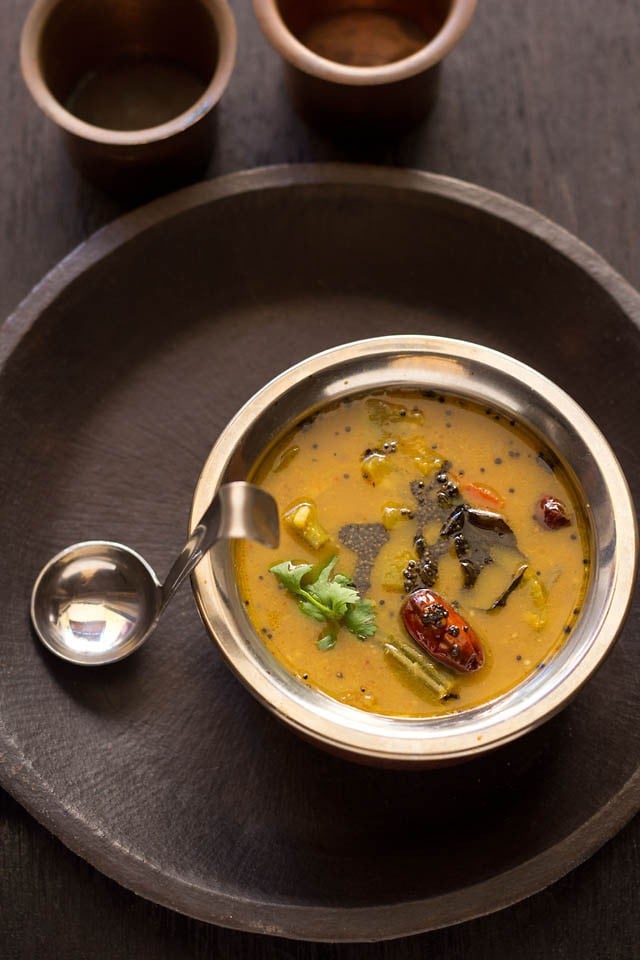 udupi sambar in a bowl with spoon