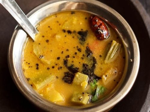 udupi sambar in a bowl with spoon