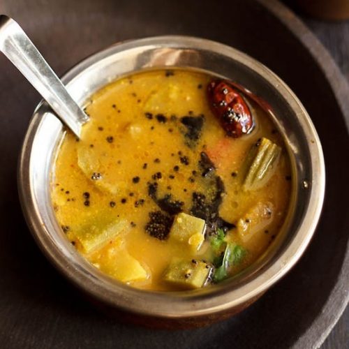 udupi sambar in a bowl with spoon