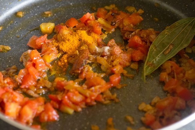 ground spices added to tomatoes