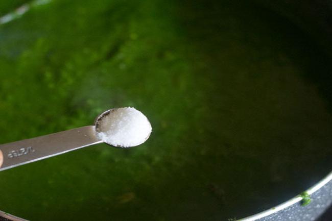 salt being added with a measuring spoon
