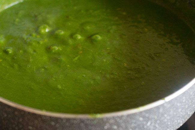 simmering spinach sauce to make aloo palak