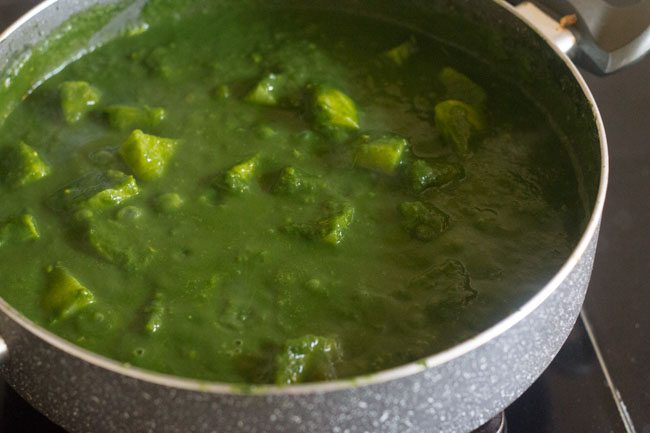 potatoes mixed with spinach gravy or sauce