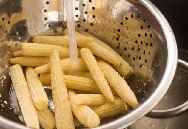 rinsing baby corn in running water