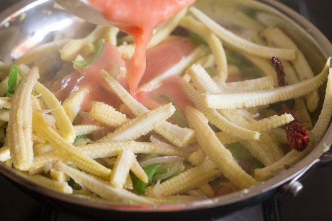 adding tomato puree in pan