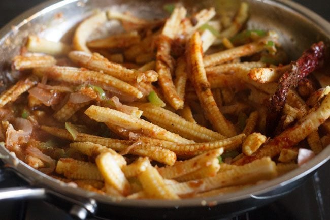 mixing the spice powders well in pan