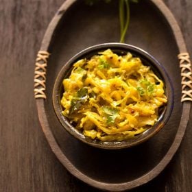 cabbage thoran in an dark earthen bowl