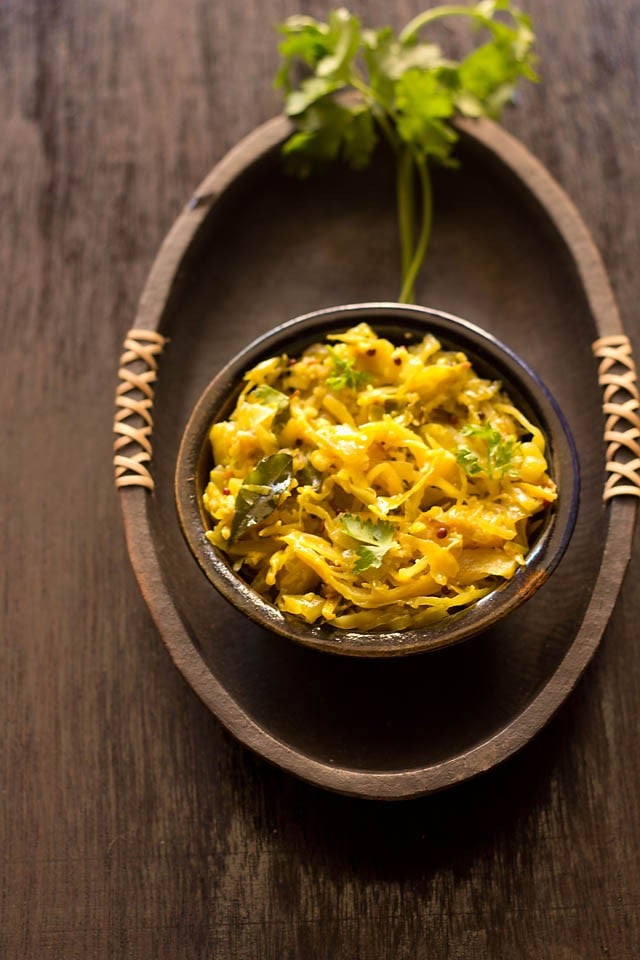 cabbage thoran in an dark earthen bowl