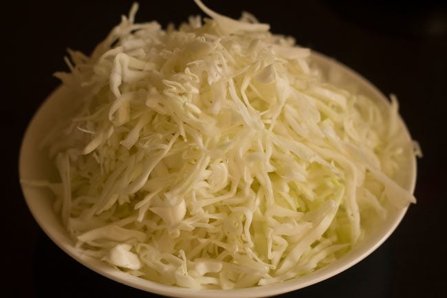 shredded cabbage on a plate to make cabbage thoran recipe