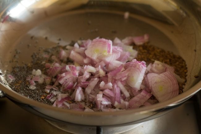 adding finely chopped onions in pan