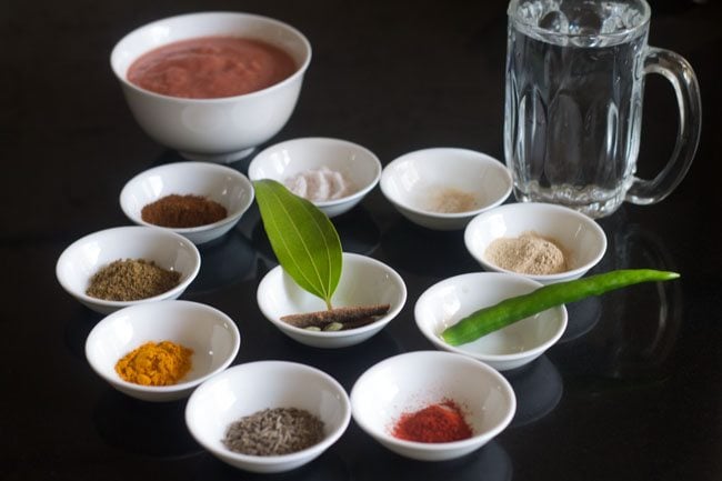 spices and other ingredients kept in individual white bowls. 