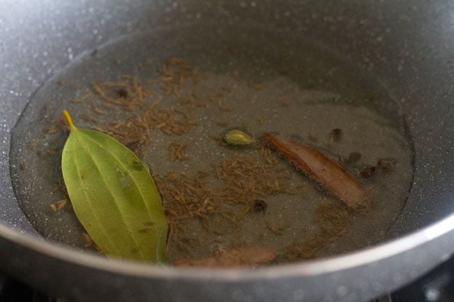 frying spices in the hot oil.