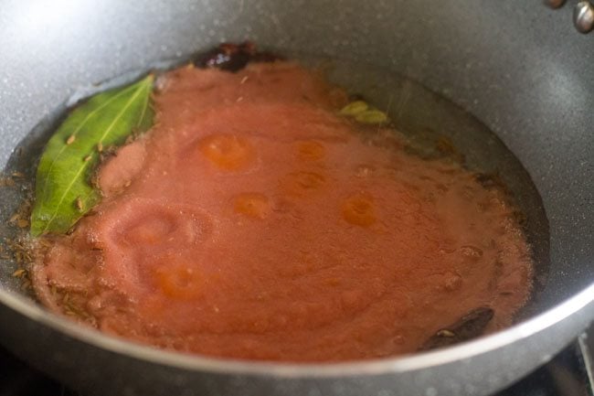 adding the ground onion, tomato, green chilli, ginger, garlic paste