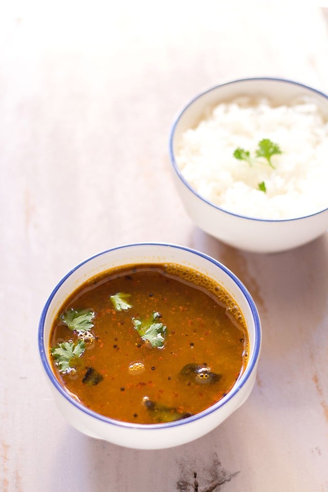 dal rasam served in a bowl with rice on side