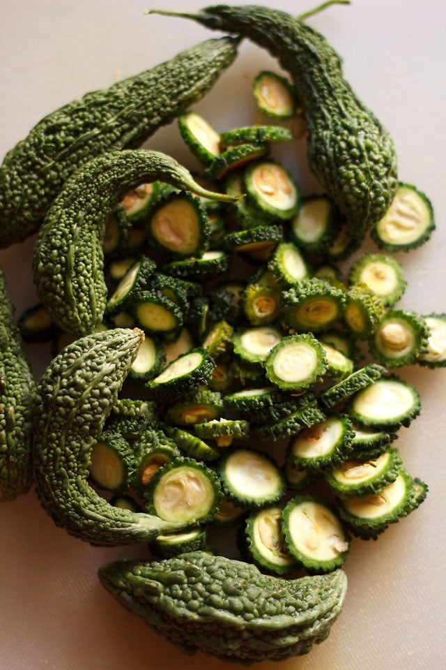 sliced and whole fresh karela or bitter gourd 