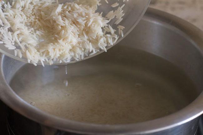 adding drained basmati rice and salt too the pan