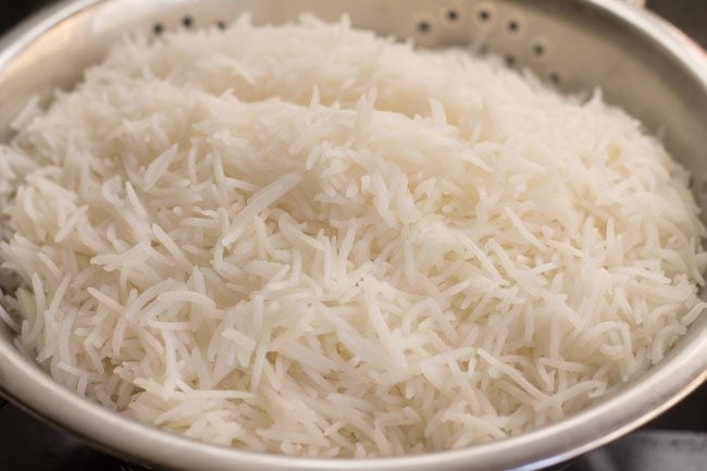draining cooked rice in a colander 