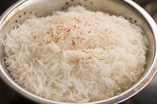 sprinkling saffron on cooked rice