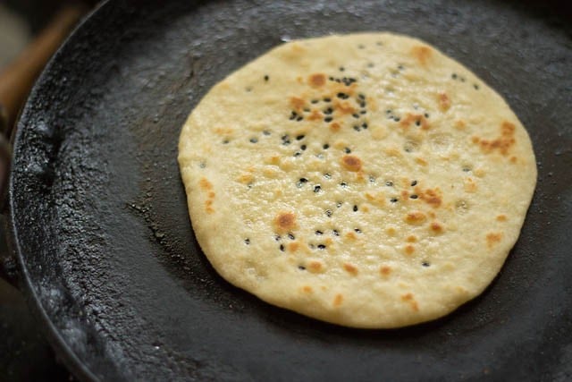 flipping and cooking the other side of the kulcha 