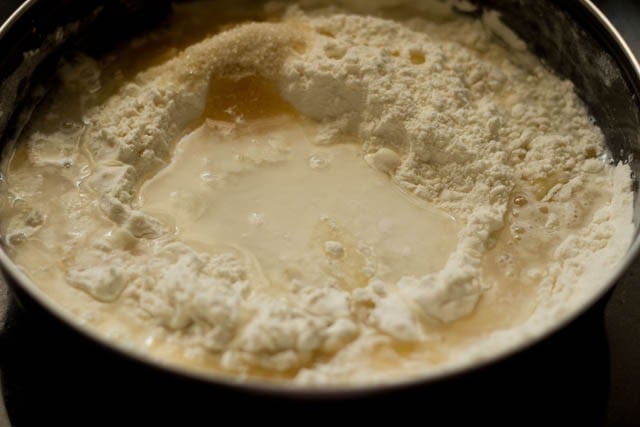 adding yogurt, oil and water in the bowl