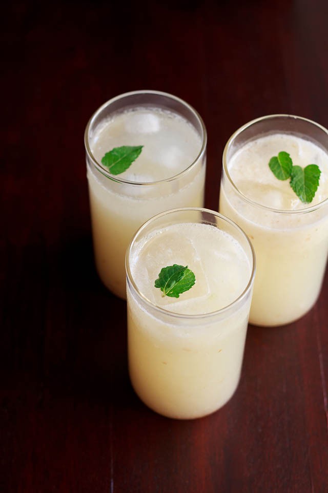 lychee juice garnished with mint leaves and served in three glasses 