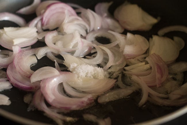 sautéing onions in hot oil in pan