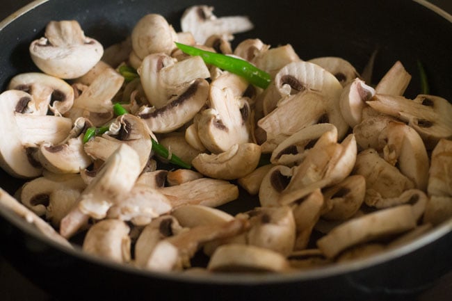 adding chopped mushrooms to the pan