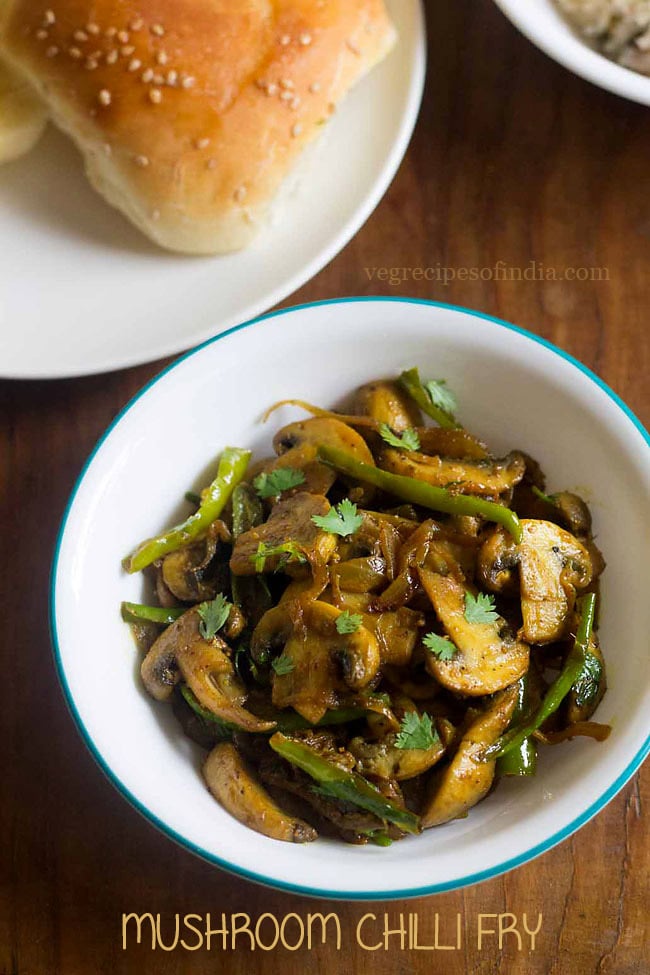 mushroom fry served in a bowl with pavs on a plate 