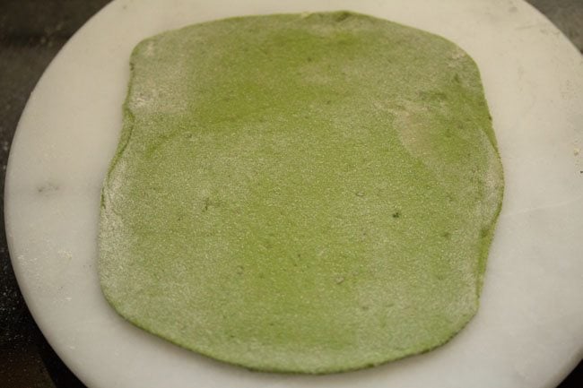 rolled palak paratha on a board