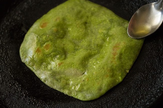 oil or ghee on the other side  of palak paratha 