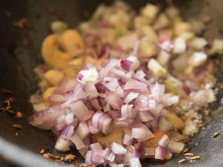 add chopped onions to urad dal and cashews