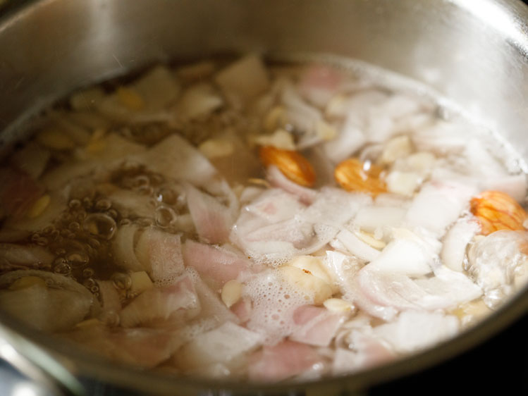 onions, nuts, seeds, garlic and ginger being simmered in water