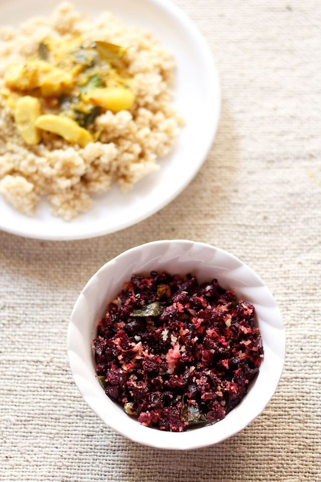 beetroot poriyal served in a white bowl with a plate of arbi-sambar and steamed foxtail millet kept on the left side. 