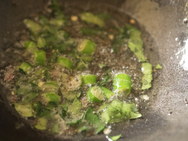 chopped green chili, chopped curry leaves and asafoetida added to the hot coconut oil in pan. 