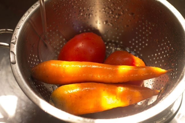 rinsing tomatoes and carrots in water 