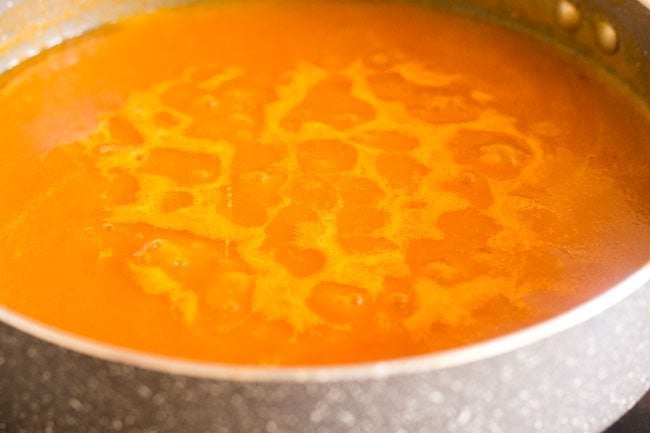 simmering tomato carrot soup in the pan