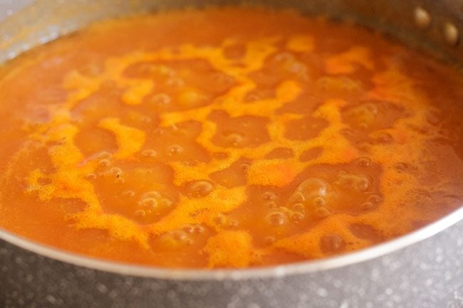 cooking tomato carrot soup in the pan