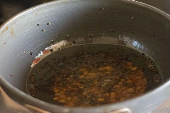 Mustard seeds are spluttering in hot oil.  