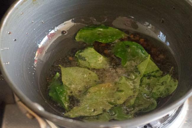 Add asafoetida and curry leaves to the oil. 